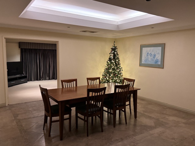 Dining room with Christmas tree and table.